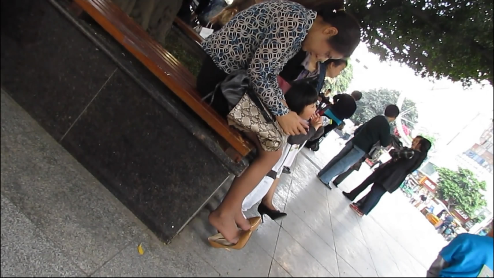 Really Bored, a Woman Play Her Cellphone and Heels